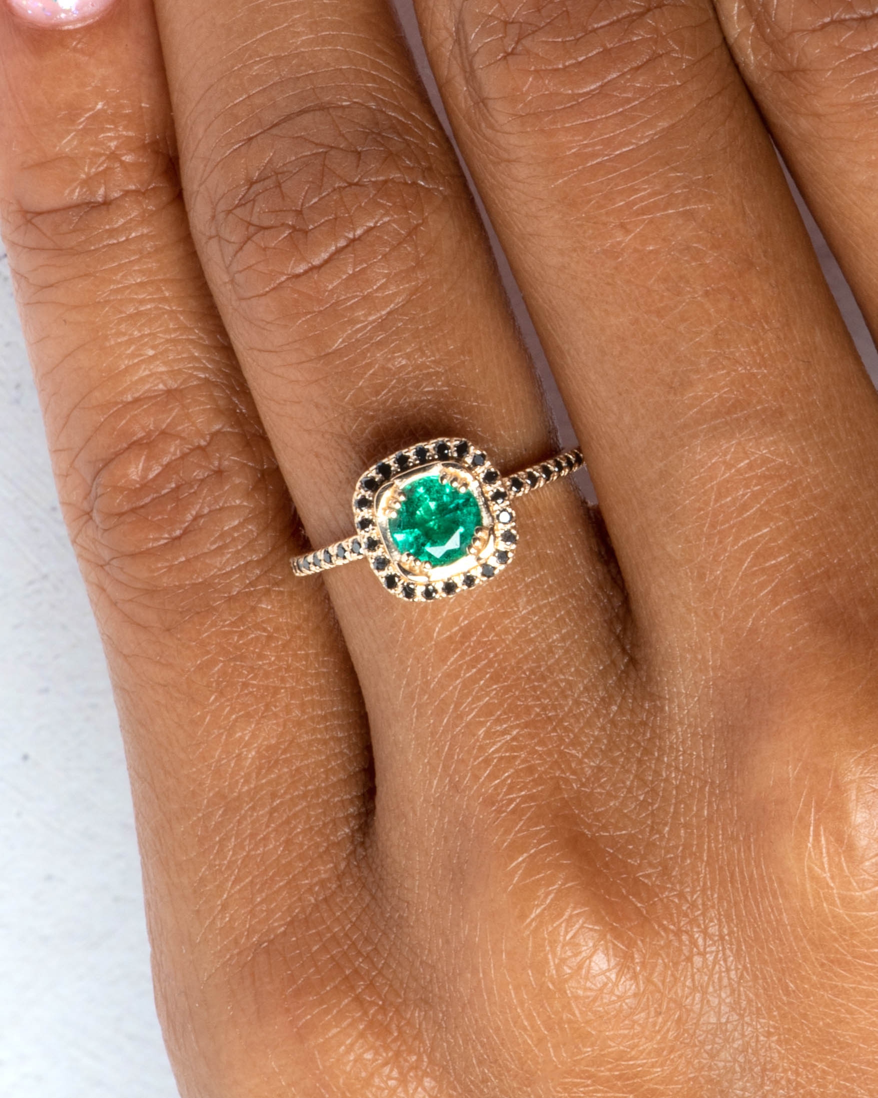 10_year_halo_on_figure_quince_emerald_with_black_diamond_halo_ring_1-2_web_2_1.jpg