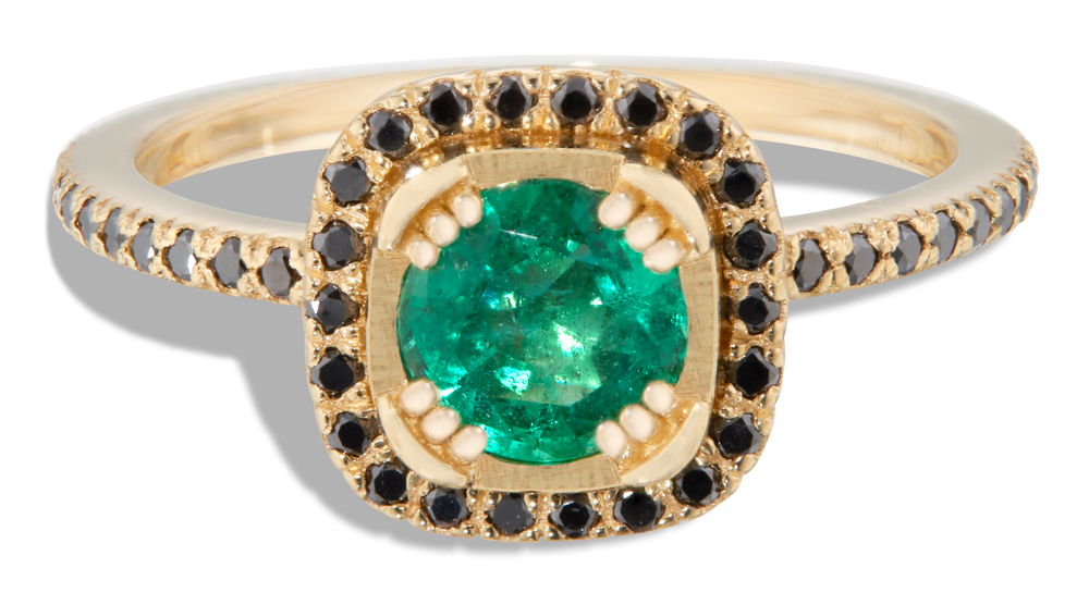 A modern interpretation of a halo ring showcasing an emerald center stone complemented by a surrounding black diamond halo.