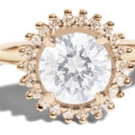 A classic halo-style ring with a dazzling diamond center stone surrounded by a sparkling diamond halo.