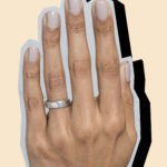 Collage image of a hand wearing a Bario Neal recycled palladium wedding band with a drop shadow.