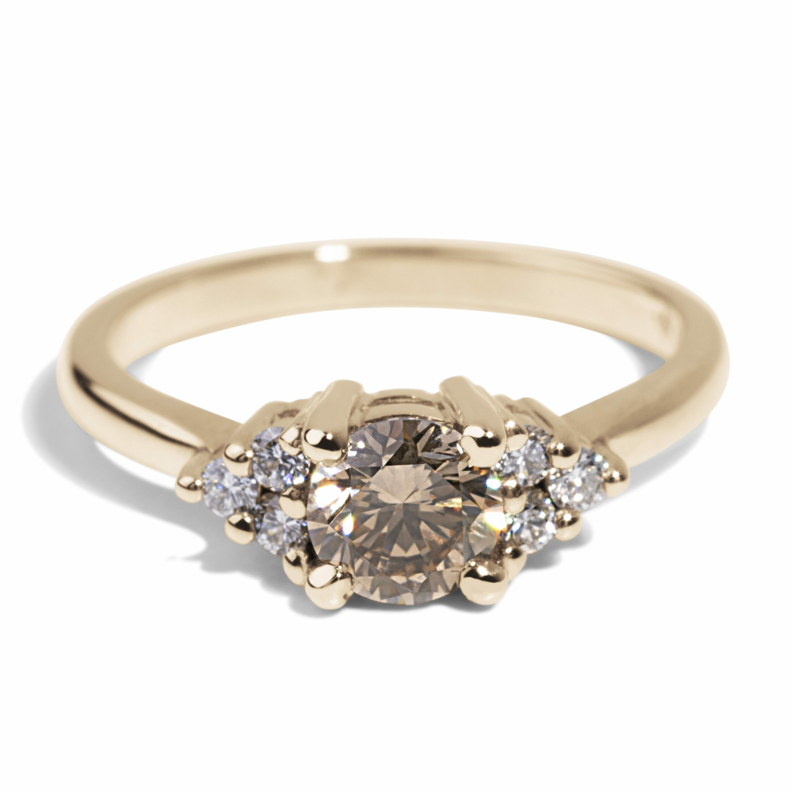 This stunning ring features a champagne diamond center stone with diamond side stones.