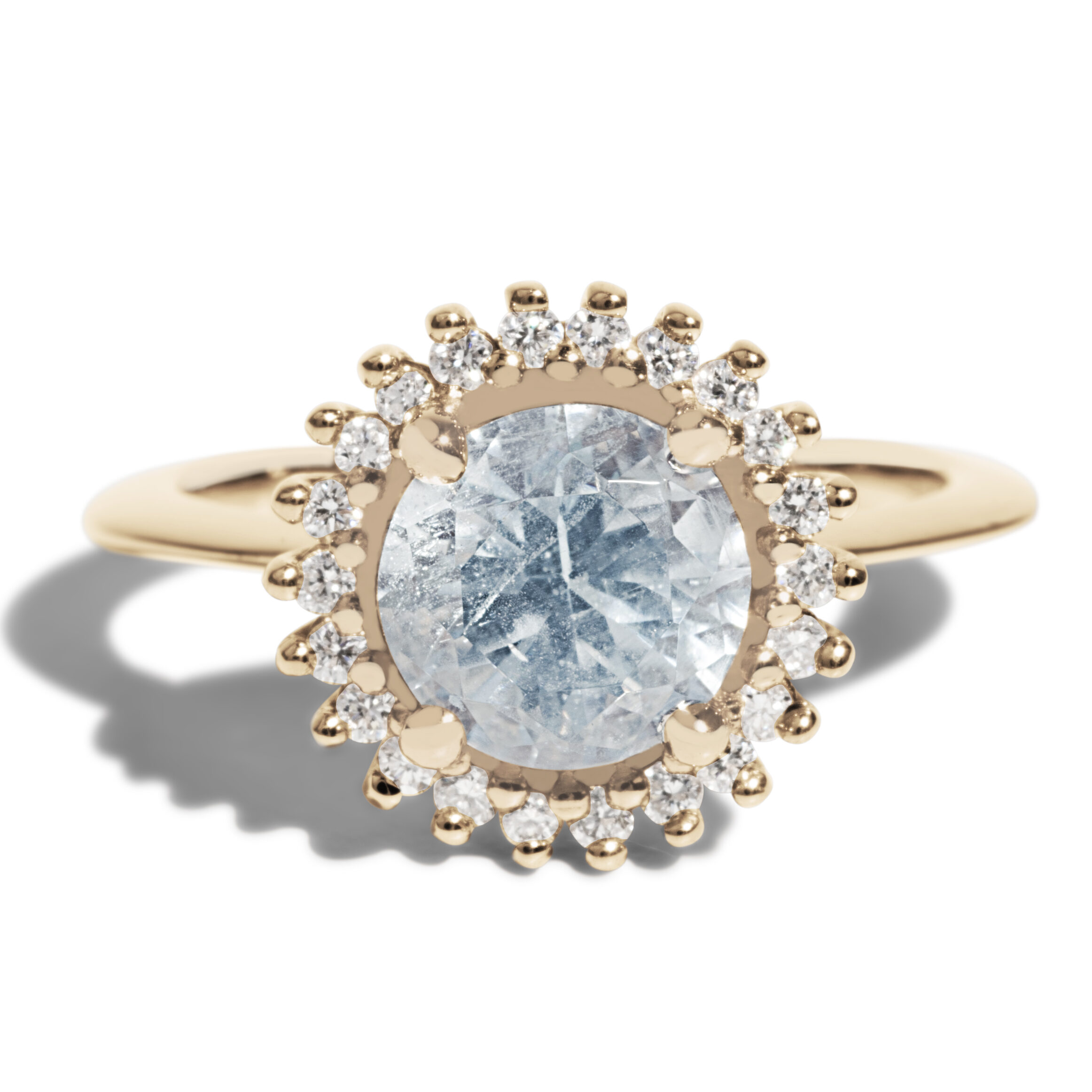This classic halo ring features a aquamarine center stone with a diamond halo.